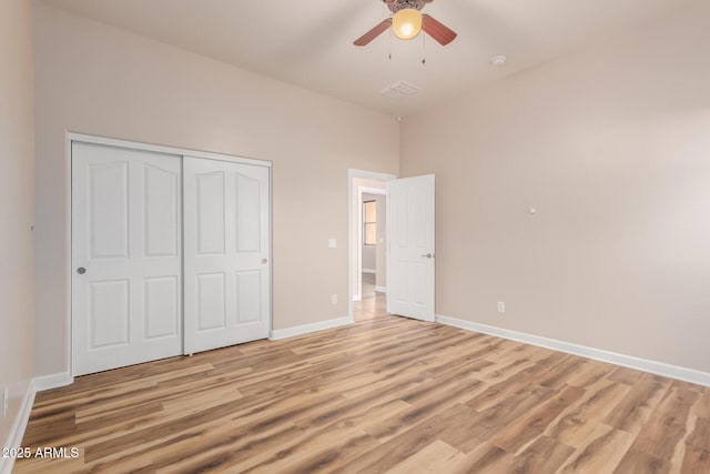 unfurnished bedroom with a closet, ceiling fan, and light hardwood / wood-style floors