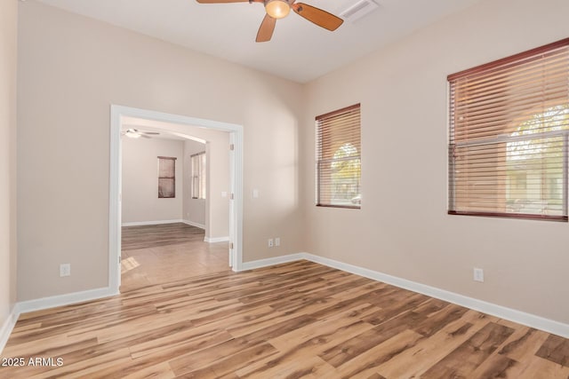 spare room with light hardwood / wood-style floors and ceiling fan