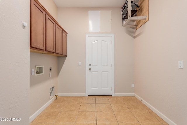 laundry room featuring washer hookup, electric dryer hookup, light tile patterned floors, and cabinets