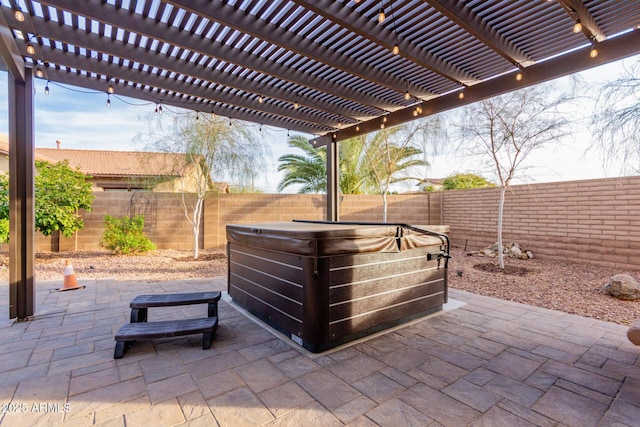 view of patio / terrace with a hot tub and a pergola