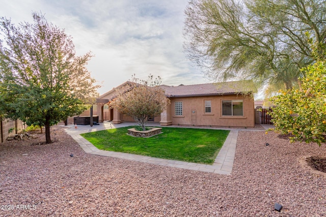 rear view of property featuring a patio and a yard