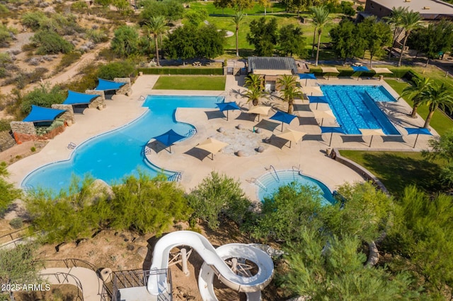 view of swimming pool featuring a patio area and a water slide