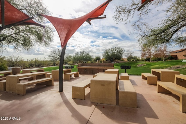 view of property's community with a yard, an outdoor hangout area, and a patio