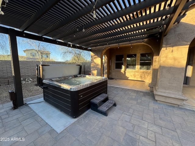 view of patio featuring a hot tub and a pergola