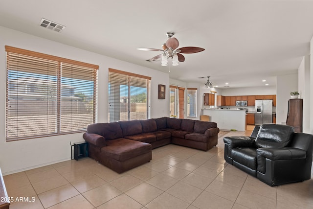 tiled living room featuring ceiling fan