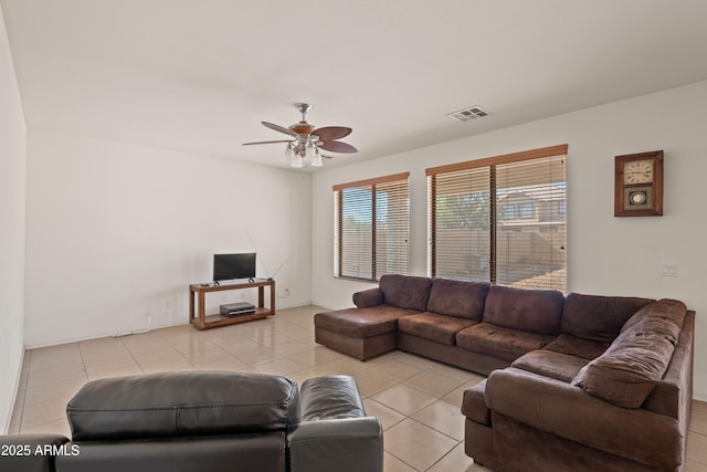 tiled living room featuring ceiling fan