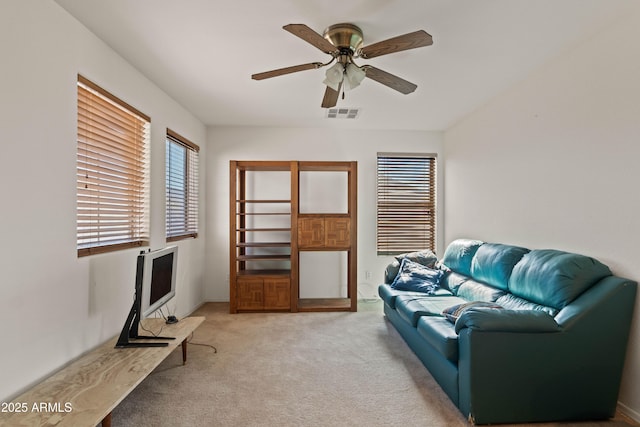 sitting room featuring ceiling fan and light colored carpet