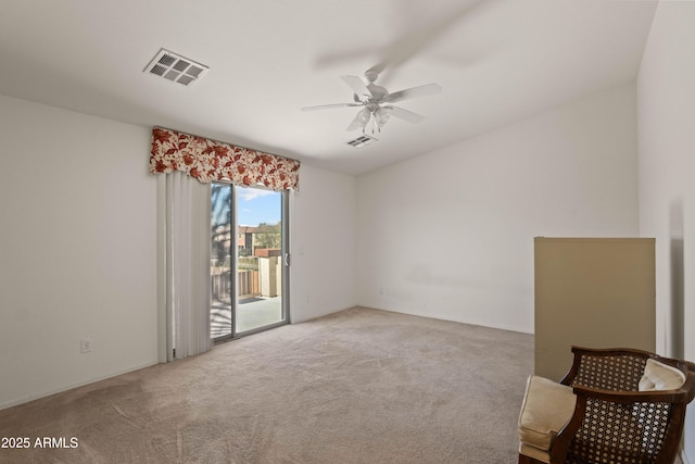 empty room with ceiling fan and light carpet