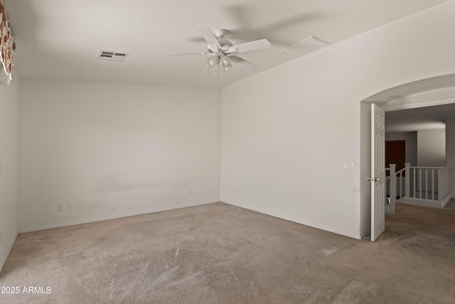 carpeted empty room featuring ceiling fan