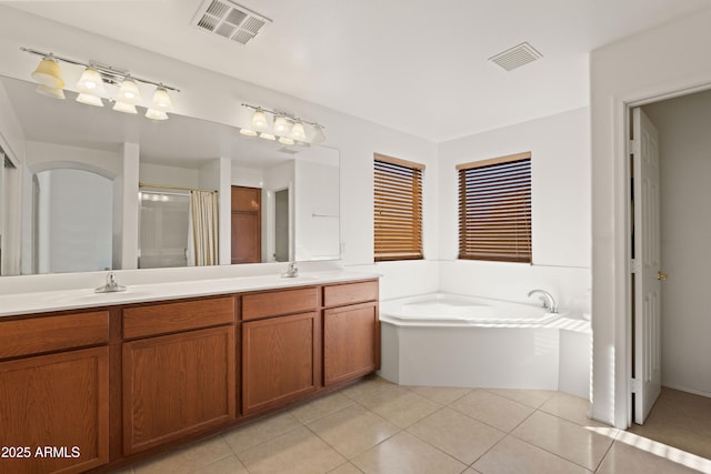 bathroom featuring vanity, independent shower and bath, and tile patterned flooring