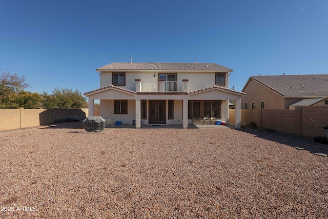 back of house with a patio