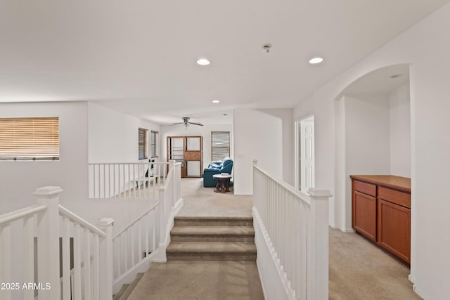 hallway featuring light colored carpet