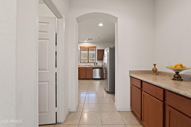 corridor with sink and light tile patterned floors