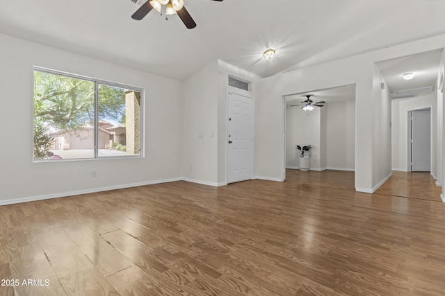 10727 E El Moro Ave, Mesa, AZ 85208 - unfurnished living room featuring vaulted ceiling, a ceiling fan, and wood finished floors