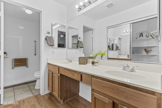 10727 E El Moro Ave, Mesa, AZ 85208 - full bath with double vanity, wood finished floors, and ceiling fan