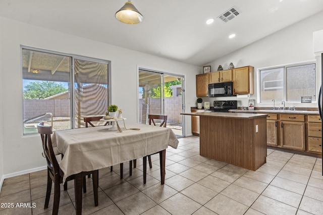 10727 E El Moro Ave, Mesa, AZ 85208 - kitchen with black microwave, electric stove, a kitchen island, vaulted ceiling, and light tile patterned floors
