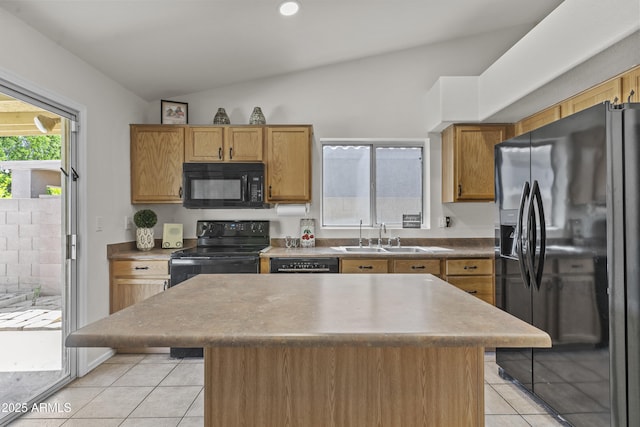 10727 E El Moro Ave, Mesa, AZ 85208 - kitchen with black appliances, light tile patterned flooring, lofted ceiling, a center island, and brown cabinetry