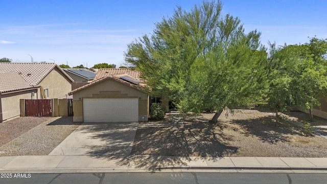 10727 E El Moro Ave, Mesa, AZ 85208 - obstructed view of property with concrete driveway, a garage, stucco siding, a tile roof, and solar panels