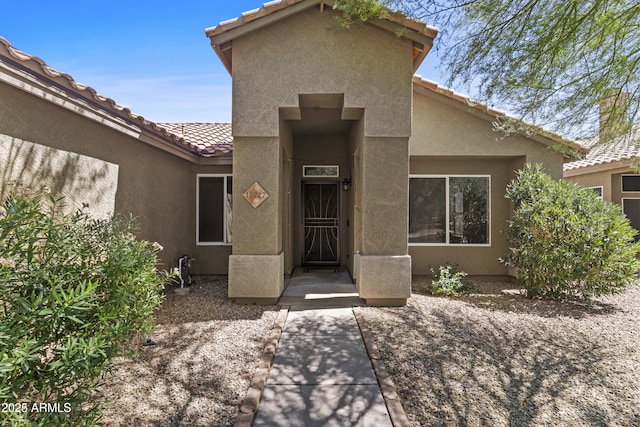 10727 E El Moro Ave, Mesa, AZ 85208 - doorway to property featuring stucco siding and a tiled roof