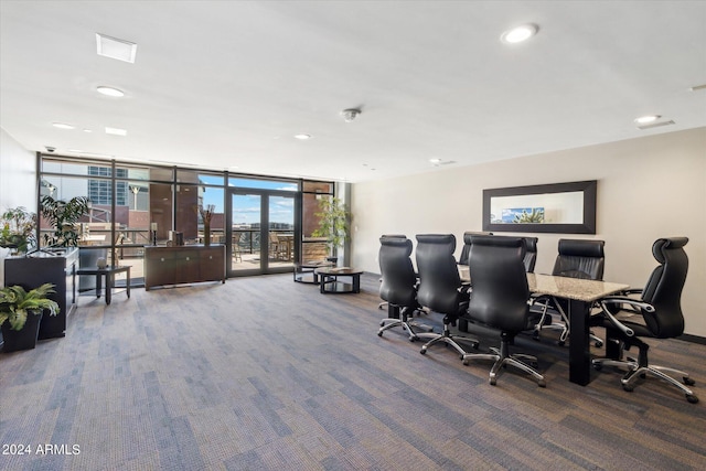 carpeted office featuring a wall of windows