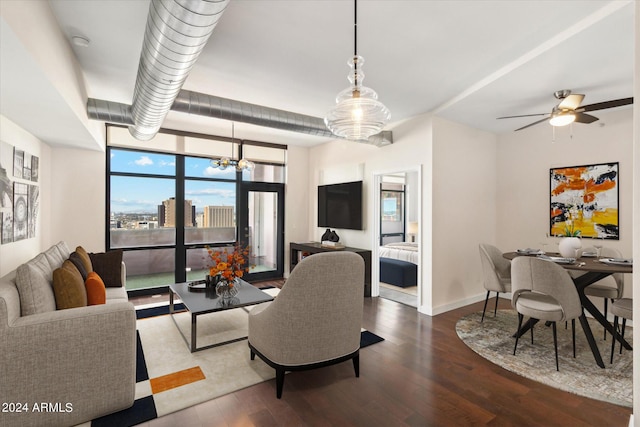 living room featuring expansive windows, ceiling fan with notable chandelier, and dark hardwood / wood-style floors