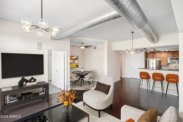 living room with ceiling fan with notable chandelier and dark hardwood / wood-style flooring