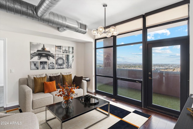 living room with a notable chandelier and dark hardwood / wood-style floors