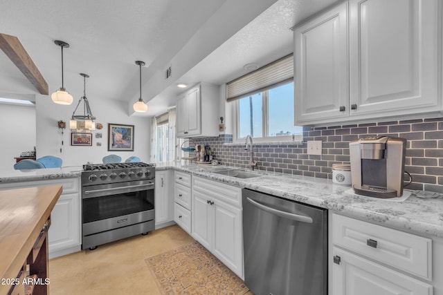 kitchen with tasteful backsplash, white cabinetry, stainless steel appliances, and a sink