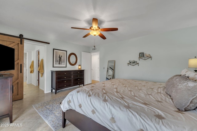 bedroom featuring a barn door, visible vents, ceiling fan, and baseboards