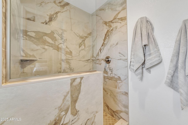 full bath with a marble finish shower