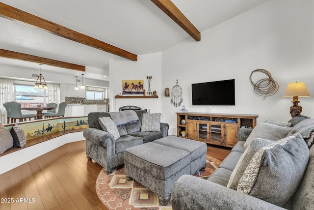 living room featuring beam ceiling, a fireplace, and hardwood / wood-style flooring