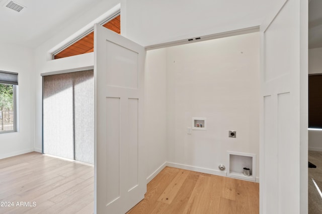 laundry room featuring electric dryer hookup, hookup for a gas dryer, washer hookup, and light wood-type flooring