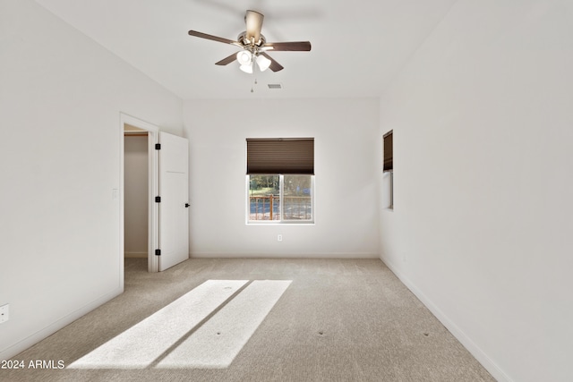 carpeted empty room with ceiling fan