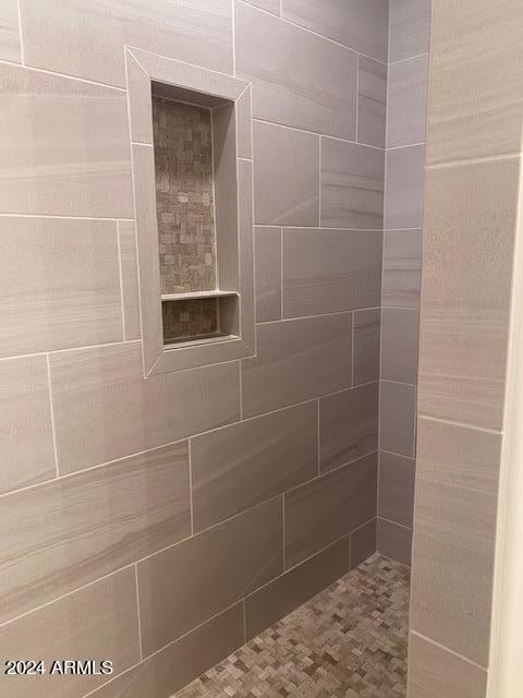 bathroom with a tile shower