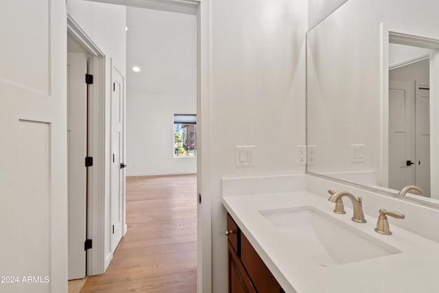 bathroom with hardwood / wood-style floors and vanity