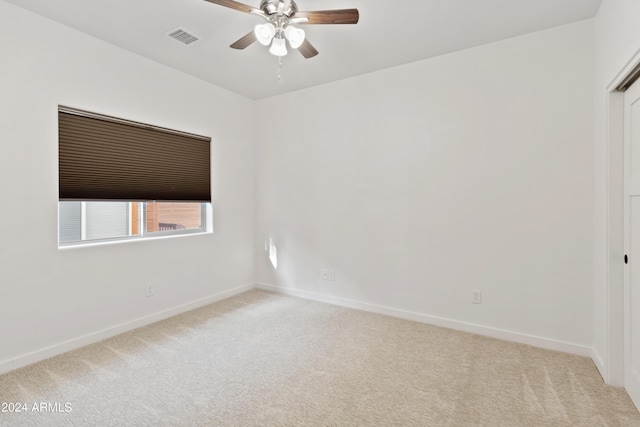 unfurnished room with ceiling fan and light carpet