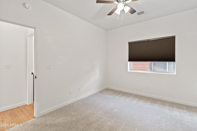 empty room with ceiling fan and light wood-type flooring