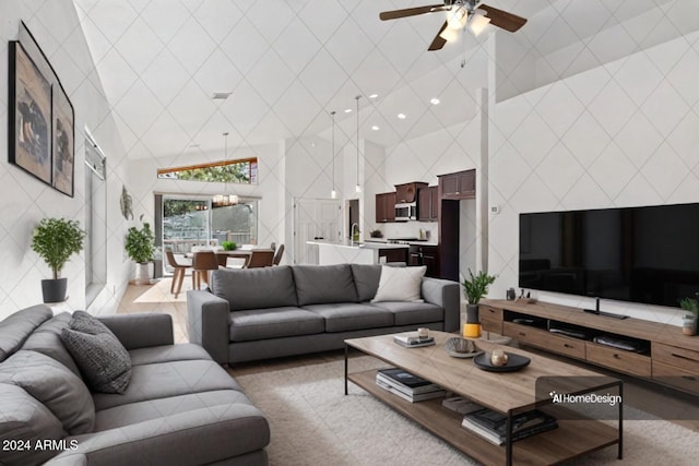 living room featuring ceiling fan, sink, and high vaulted ceiling