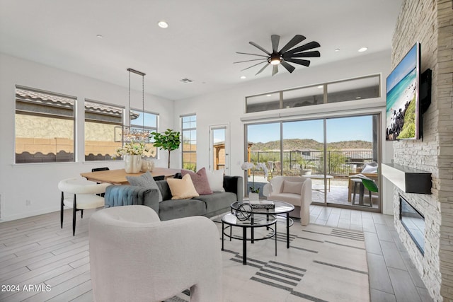 living room with visible vents, recessed lighting, a fireplace, light wood finished floors, and baseboards