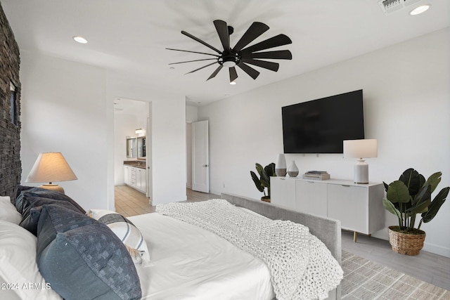 bedroom with visible vents, recessed lighting, light wood-style flooring, ensuite bath, and a ceiling fan