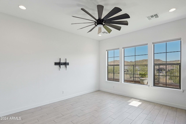 unfurnished room featuring baseboards, visible vents, recessed lighting, ceiling fan, and light wood-type flooring