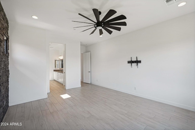 interior space with light wood-type flooring, baseboards, visible vents, and a ceiling fan