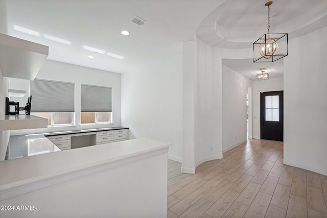 kitchen with visible vents, recessed lighting, light wood-style floors, baseboards, and hanging light fixtures