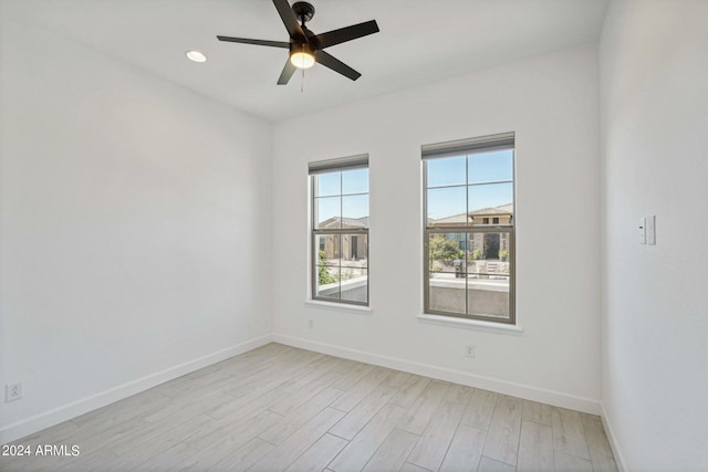 empty room featuring recessed lighting, baseboards, light wood-style flooring, and a ceiling fan