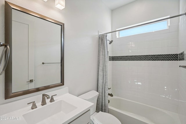 full bath featuring vanity, toilet, and shower / tub combo