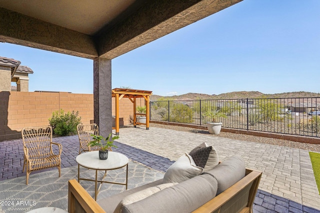 view of patio with a mountain view, fence, outdoor lounge area, and a pergola