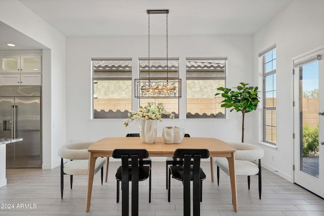 dining area featuring a notable chandelier, recessed lighting, and baseboards