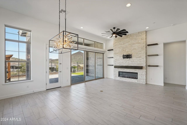 unfurnished living room with recessed lighting, wood finished floors, a fireplace, and a ceiling fan