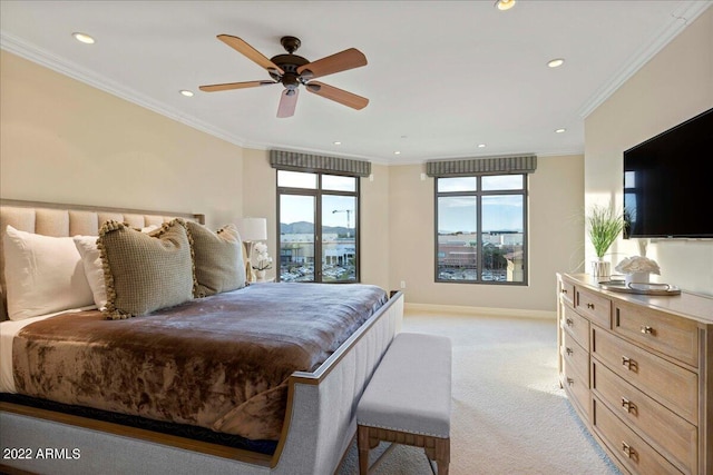 carpeted bedroom featuring ceiling fan and crown molding