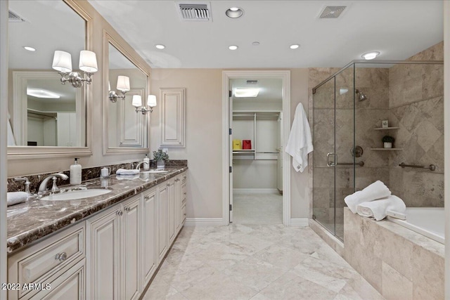 bathroom featuring vanity and separate shower and tub